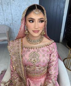 a woman wearing a pink bridal outfit