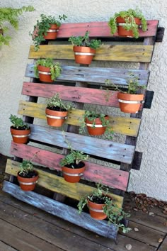 a wooden pallet with potted plants on it