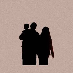 two people are standing in the dark with their arms around each other's shoulders