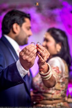 a man and woman holding something in their hands