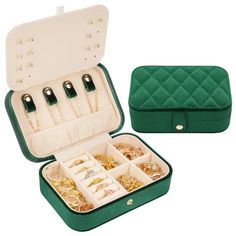 an open green case filled with lots of jewelry