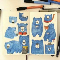 an open notebook with blue bears drawn on it and some crayons next to it