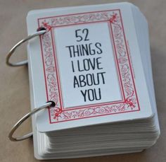 an open book with the words 52 things i love about you written on it and two binders