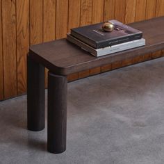 a wooden bench with two books on it