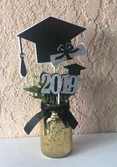 a graduation decoration in a mason jar