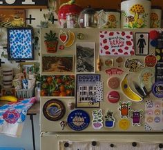 a refrigerator covered in magnets and pictures