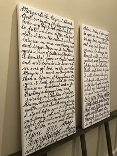 two white canvass with black writing on them hanging on a wall next to each other