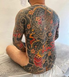 a man with a dragon tattoo on his back