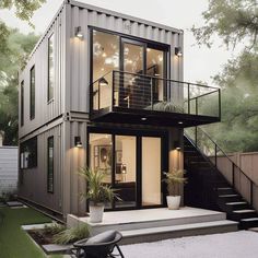 a house made out of shipping containers with stairs leading up to it