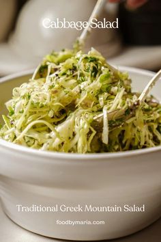 a white bowl filled with coleslaw salad on top of a table