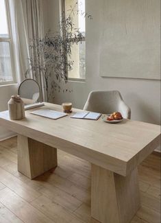 a wooden table sitting in front of a window