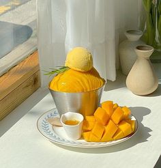 a plate that has some kind of fruit on it and is next to a vase