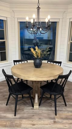 a dining room table with four chairs around it