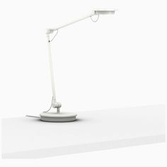 a white desk lamp sitting on top of a table