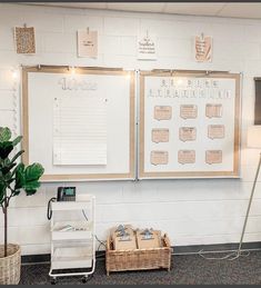 a white board with writing on it next to a lamp and some baskets in front of it