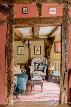 a living room filled with furniture and paintings on the walls