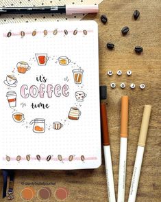 an open notebook with coffee and eyeliners on it