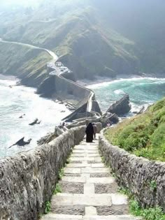 a person walking up some steps near the ocean