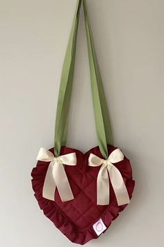 a heart shaped purse hanging on the wall