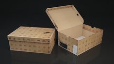 an open box sitting on top of a table next to another box with the lid closed