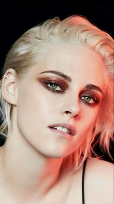 a woman with blonde hair and green eyes