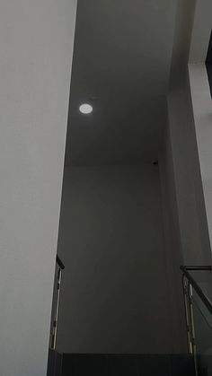 the light is on at the top of the stairs in the building's stairwell