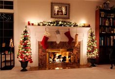 a fireplace decorated for christmas with stockings hanging from the mantle