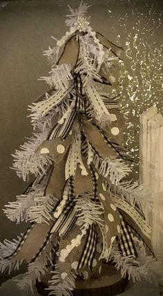 a white christmas tree sitting on top of a wooden table