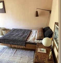 a bed sitting in the corner of a room next to a wall