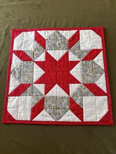 a red and white quilted table topper