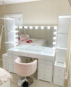 a white vanity table with lights on it