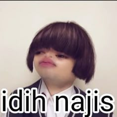 a young boy wearing a suit and tie with the words idh najis on it