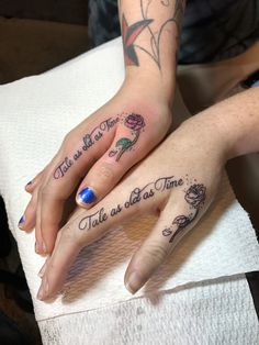 two people with matching tattoos on their hands