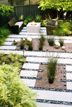 an outdoor patio area with stone steps and graveled walkways, surrounded by greenery