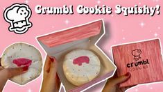 a pink box with two cookies in it and the words crumb cookie squishy