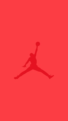 the silhouette of a basketball player jumping up in the air with a ball on his hand