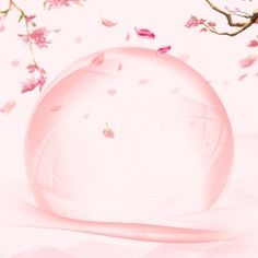 a pink ball sitting on top of a white surface next to a tree with flowers