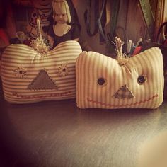 two decorative pillows are sitting on a table