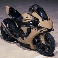 a tan motorcycle parked on top of a parking lot