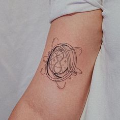 a woman's arm with a clock tattoo on the left side of her body