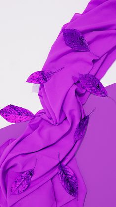 an image of a purple scarf with flowers on the side and leaves on the other side