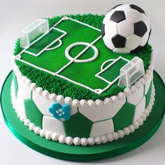 a soccer themed cake with green frosting and white icing