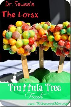 the fruit tree is made with gummy's and green apples on sticks in front of a sign that says, dr seuss's the lorax