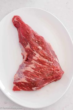 a piece of raw meat on a white plate