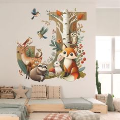 a room with a couch and wall decals on the walls, including an image of animals