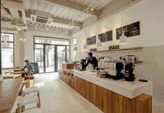 the coffee shop is clean and ready for customers to use their machines as they wait