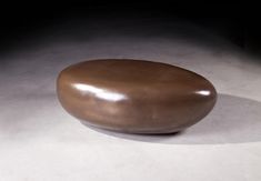 a large brown stone sitting on top of a white floor