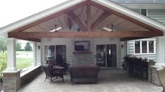 a covered patio area with chairs and tables