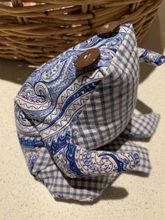 a blue and white patterned bag sitting on top of a counter next to a basket