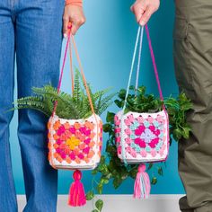 two people are holding small baskets with plants in them and one is holding a potted plant